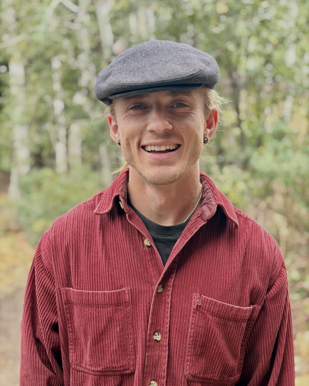 Willoughby Bourne, licensed massage therapist, photographed outdoors among aspens